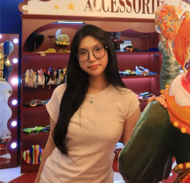 Chau Thao standing beside a colorful display